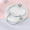 Sterling silver devil's eye charm bracelet with pink stones displayed on a white background