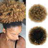 Close-up of a woman with a voluminous, curly brown hair extension styled in a ponytail.