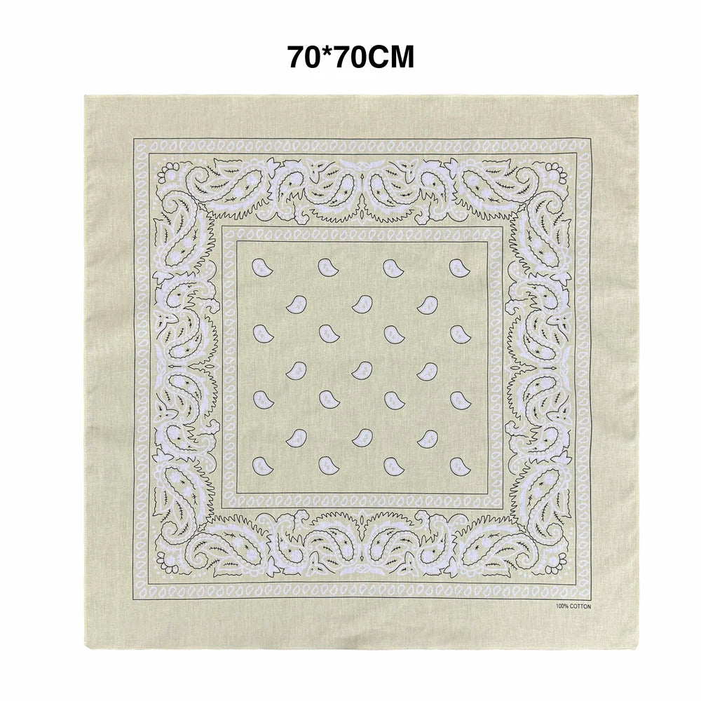 A beige cotton square featuring a delicate white paisley border and a central pattern of light blue oval shapes.