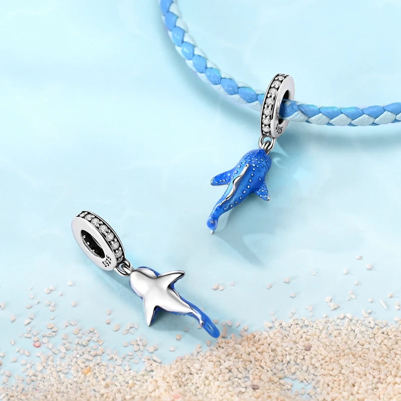 Sterling silver devil's eye charm bracelet featuring a blue charm and a blue beaded chain