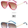 A pair of pink aviator-style sunglasses with gold accents shown in a studio setting.