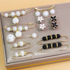 A set of adjustable pearl jewelry including necklaces, earrings, and bracelets displayed in a rectangular box.