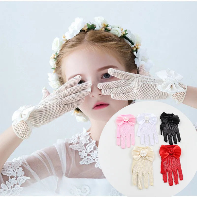 A young woman models bridal mesh finger gloves on her hand against a white background.