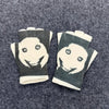 Pair of Y2K retro printed fingerless knit gloves featuring a white face design on a dark green background