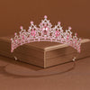 A pink crystal baroque bridal tiara headpiece displayed on a square box.