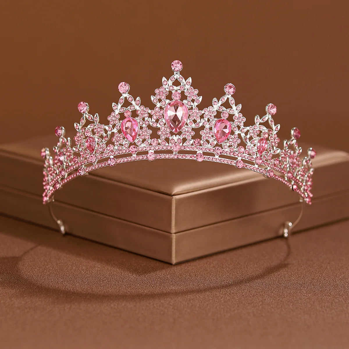 A pink crystal baroque bridal tiara headpiece displayed on a square box.