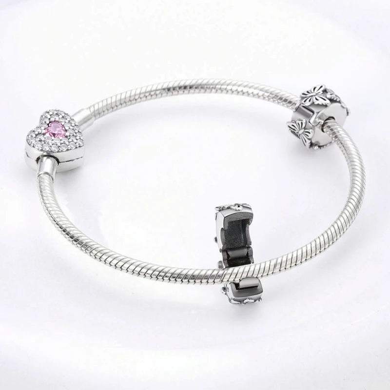 Sterling silver devil's eye charm bracelet with a heart charm and a dark stone charm
