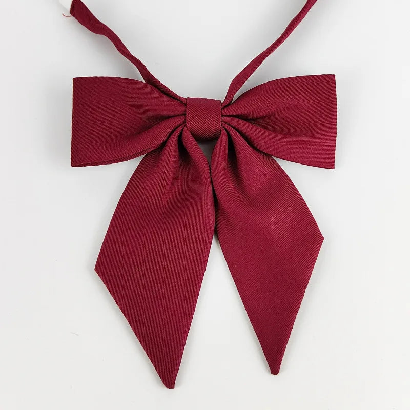 A deep red bow tie ribbon set with a butterfly shape for students