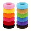 A stack of multi-color cotton elastic hair ties in various shades including pink, yellow, orange, red, and black.