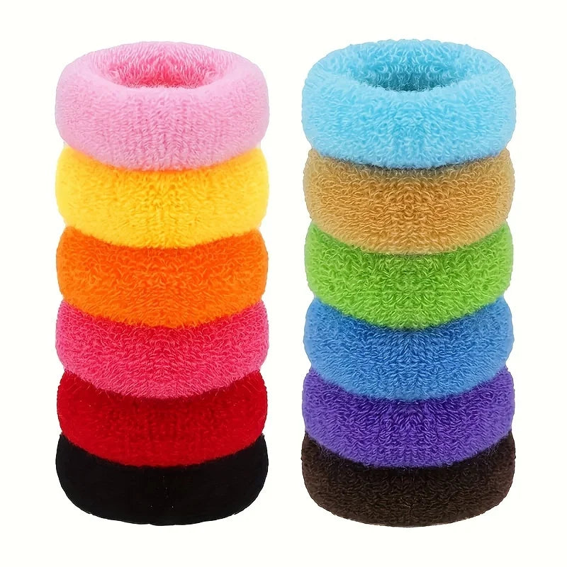 A stack of multi-color cotton elastic hair ties in various shades including pink, yellow, orange, red, and black.