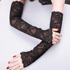 Black lace anti-sunburn arm sleeves worn on a person's arm.