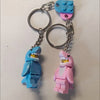 A set of heart-shaped building blocks in blue and pink, attached to metal split rings for a keychain.