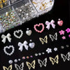 A collection of pink and white butterfly bow nail charms, including various sizes and glitter finishes.
