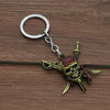 Silver split ring necklace featuring a green skull pendant with red accents.