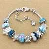 Silver bracelet featuring multi-element beads in shades of blue and white with star and heart charms