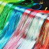 A close-up of various colored glitter hair extensions in vibrant shades like green, blue, pink, and red.