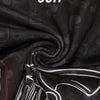 Black soft fabric material with a subtle pattern, showing a close-up texture.