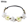 A white bohemian flower headband made of dried natural elements and fabric.