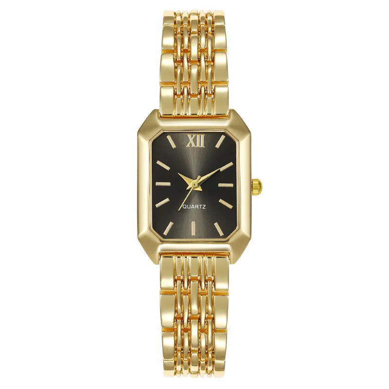 A gold minimalist quartz watch with a black dial and gold-toned links on a white background.