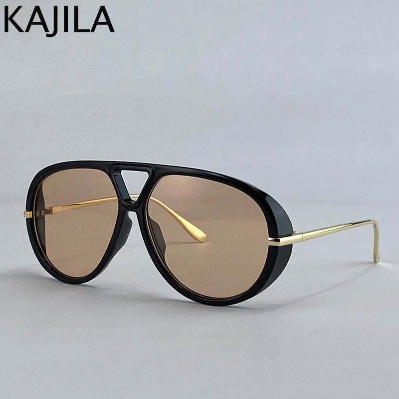 Gafas piloto vintage negras oversize con detalles dorados sobre fondo gris claro