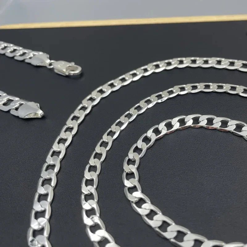 Silver geometric face chain necklace displayed on a dark background