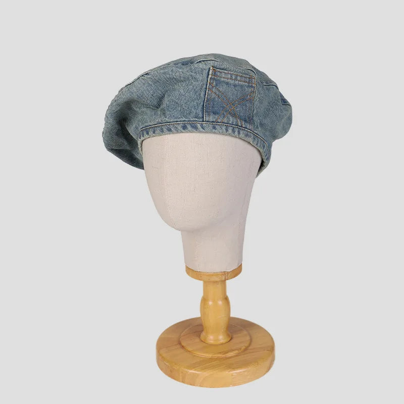 A light blue retro washed cotton denim beret hat displayed on a headless mannequin.