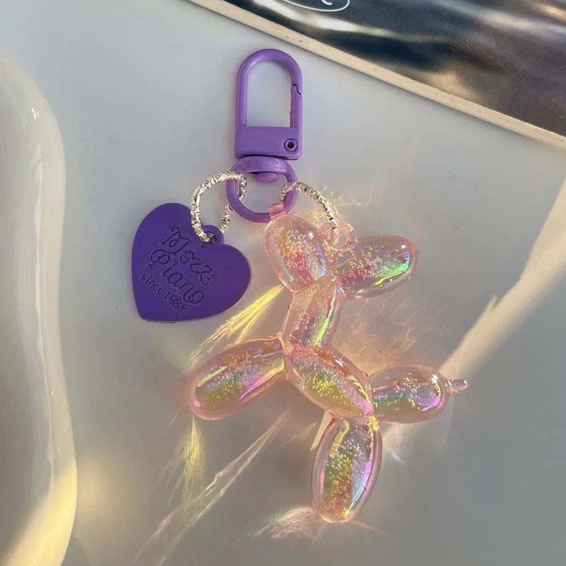 A purple keychain featuring a translucent, glittery cartoon dog charm.