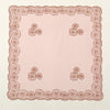 A pale pink bandana headscarf with a delicate floral embroidered lace border and scattered rose motifs.