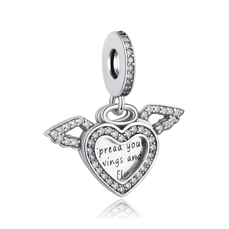 A silver heart-shaped charm with a family tree design and the inscription I pray you wings and fly.