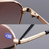 Close-up of gold-toned bifocal reading glasses frame and temple detail.