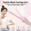 A woman is using a pink wool curling iron for hair styling, demonstrating the tool's features.