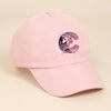 A pink baseball cap featuring a purple and iridescent unicorn letter C embroidered on the front.