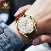 A close-up of a gold men's chronograph wristwatch with a brown leather strap on a wrist.