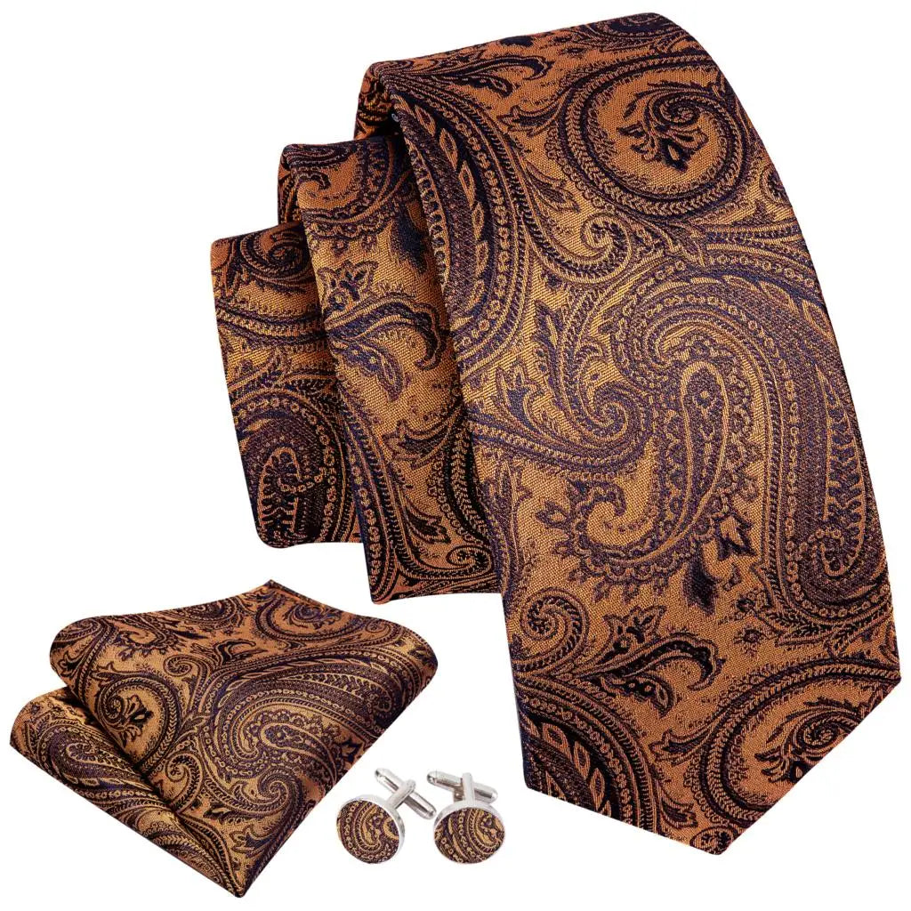 A set of men's silk jacquard ties in brown and gold paisley patterns rolled together.
