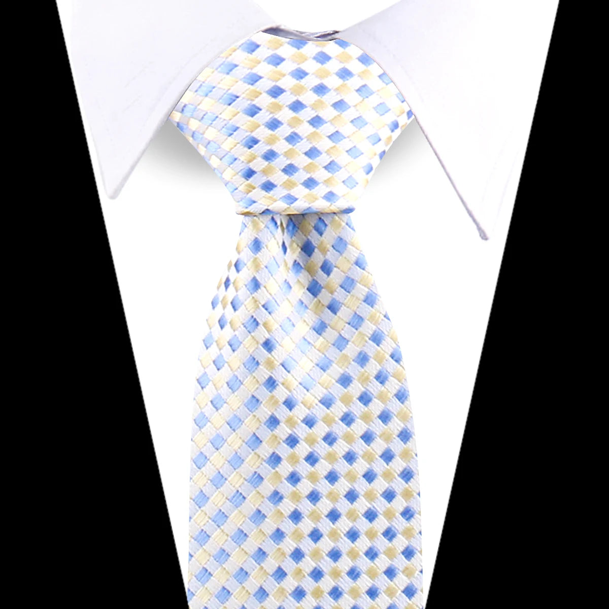 A light blue and yellow diamond patterned silk necktie worn under a white dress shirt.