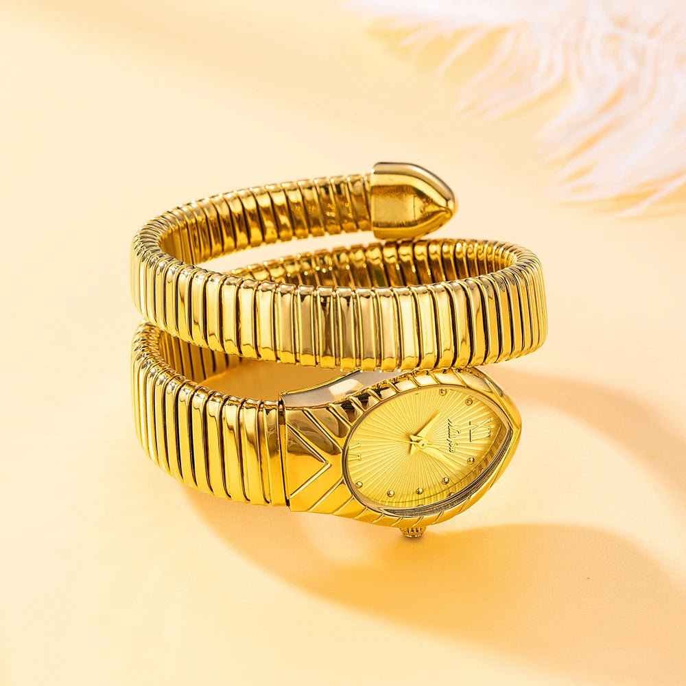 A gold quartz watch with a snake design is shown coiled on a light orange background.