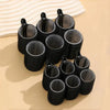 A collection of 18 self-gripping hair rollers in black, arranged on a light surface.