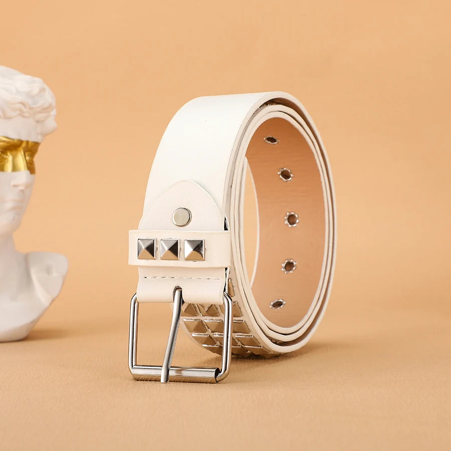 A white leather belt with silver rivets and a buckle is displayed next to a white bust.