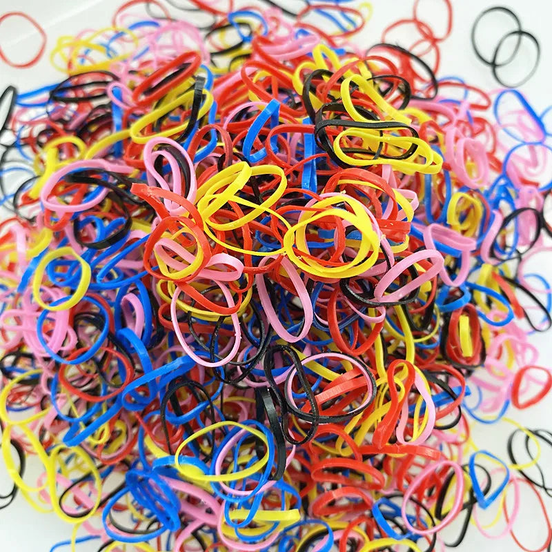 A pile of colorful disposable hair scrunchies in various bright colors like pink, yellow, blue, and red.
