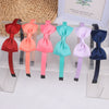 A display of nine decorative grosgrain ribbon hair bows in various shades of pink, orange, teal, and purple.