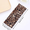 A brown leopard print fabric headband shown flat with measurements.