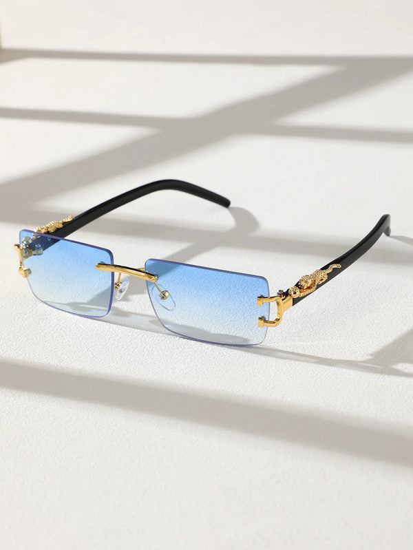A pair of trendy frameless rectangular sunglasses with blue mirrored lenses and gold accents resting on a white surface.