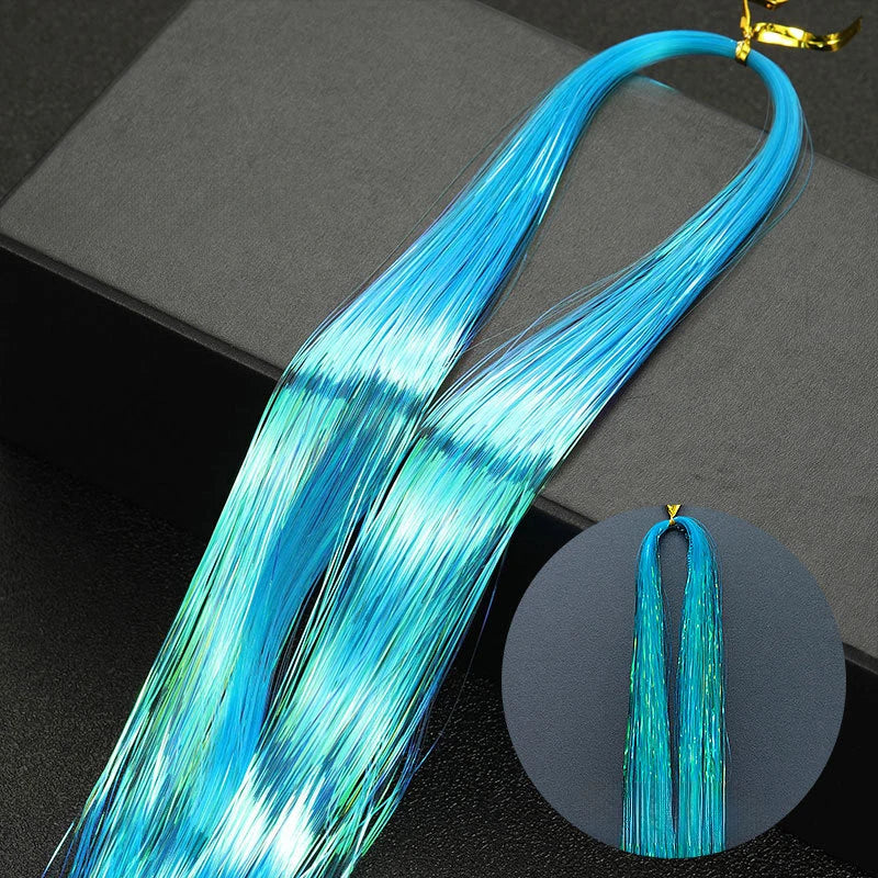 Long, bright blue glitter hair extensions shown in a bundle with gold clasps.
