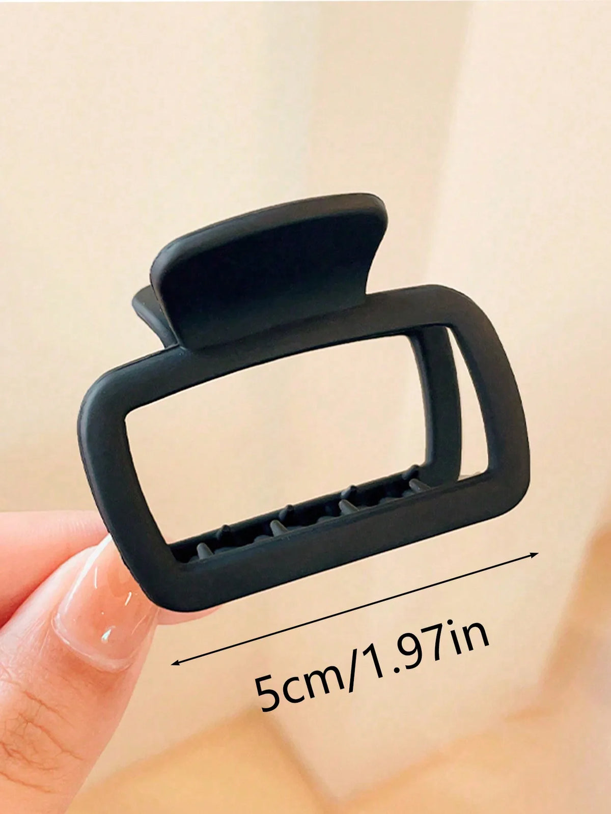 A black square lightweight hair claw clip is shown being held by a hand, with a measurement of 5cm/1.97in visible.