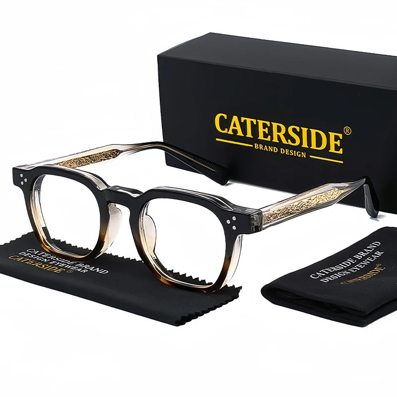 A pair of black-framed eyeglasses with gold accents resting on a black box and a black case.