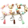 A set of silicone wristlets featuring cute Highland cow designs and tassel charms.