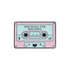 A pink and teal cassette tape enamel pin featuring the text Sad Music for Bad Days