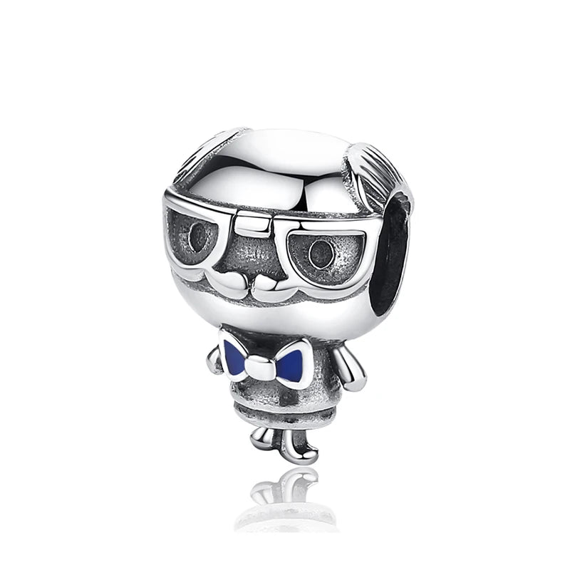 A silver family tree charm jewelry piece featuring a stylized face and bow detail.