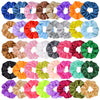 A collection of colorful satin scrunchies in various shades including blue, pink, orange, and green.