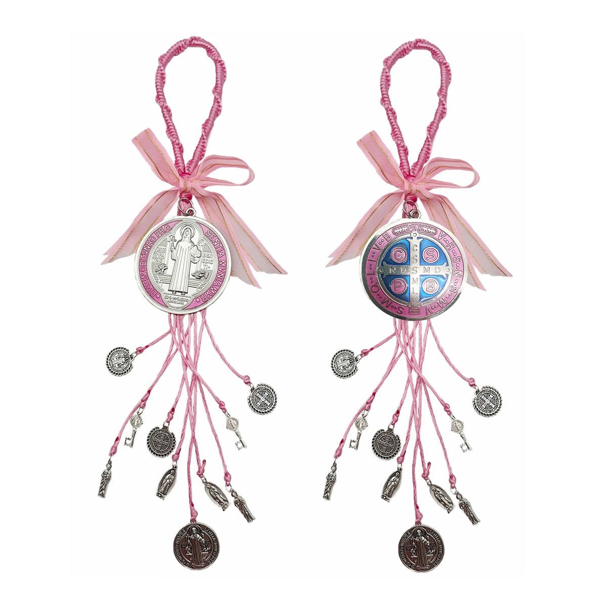 A set of pink and silver Saint Benedict protection charms with ribbons and dangling elements.